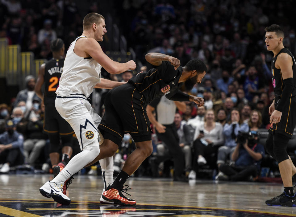 DENVER, CO - NOVEMBER 8: Nikola Jokic (15) of the Denver Nuggets hits Markieff Morris (8) of the Miami Heat with a retaliatory blow after Morris bumped Jokic near mid court during the fourth quarter of Denver