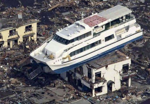 This aerial shot shows a pleasure boat sitting on top of a building amid a sea of debris in Otsuchi, in Iwate prefecture