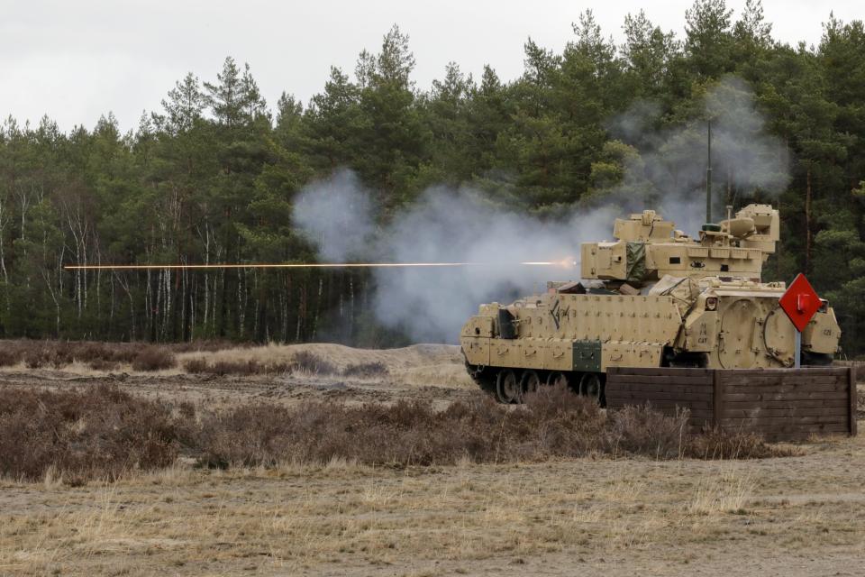A US Army M2 Bradley Infantry Fighting Vehicle assigned to the 1st Squadron, 4th Cavalry Regiment, 1st Armored Brigade Combat Team, 1st Infantry Division fires its weapon at Trzebien, Poland, Feb. 22, 2022.
