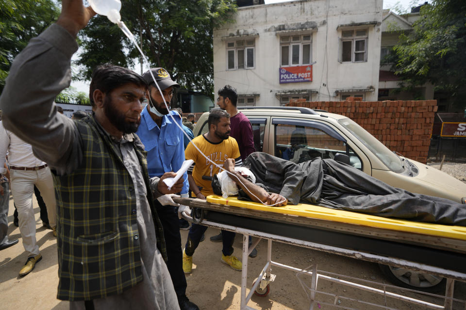 A passenger injured in a bus accident in Jammu and Kashmir's Poonch district is brought for treatment at a hospital in Jammu, India, Wednesday, Sept.14, 2022. Nearly a dozen people died and more people were injured when a mini-bus plunged into a deep gorge Wednesday. (AP Photo/Channi Anand)