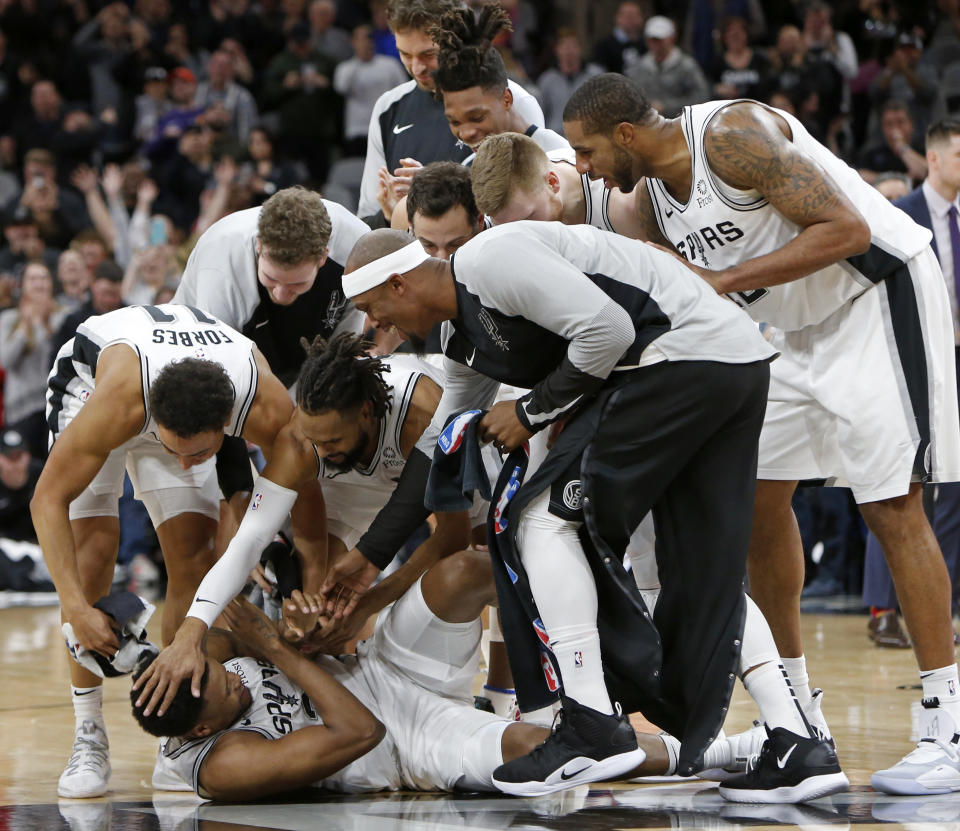 Rudy Gay was mobbed by his teammates after hitting a game-winning shot against the Suns. (Getty Images)