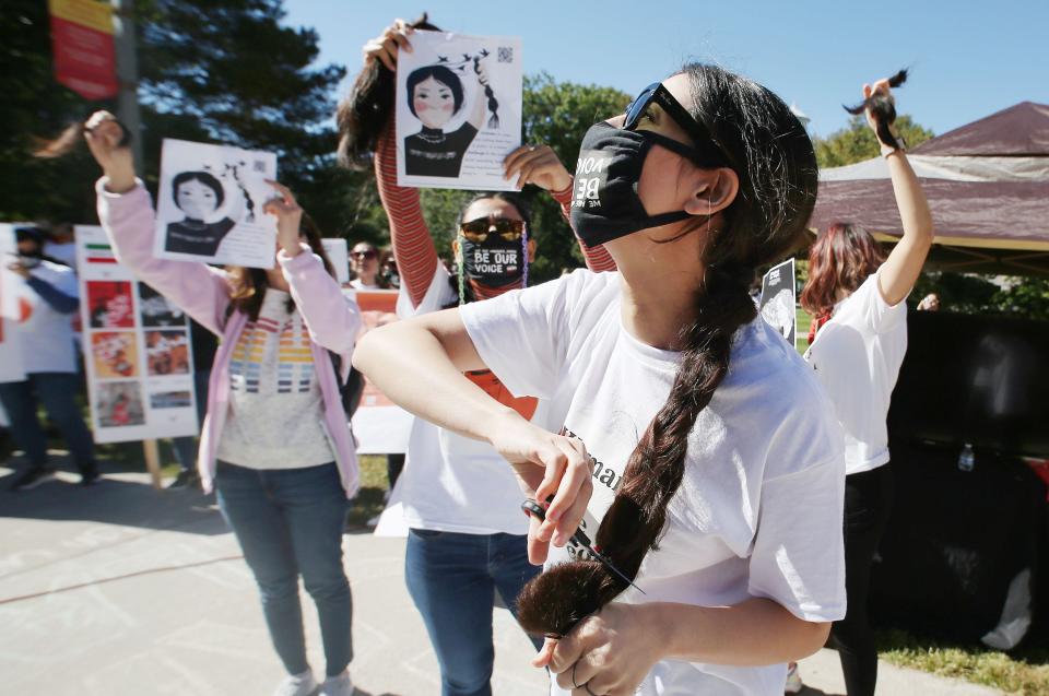 An Iranian student at Iowa State cuts her hair in a show of defiance Thursday. Thousands of Iranian people are protesting for the rights of women and their bodies.