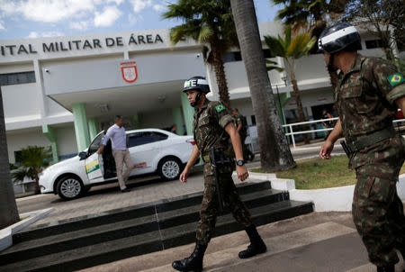 Soldiers walk in front of the Army Hospital, where Brazil's President Michel Temer was taken due to a urinary tract obstruction, his office said, in Brasilia, Brazil October 25, 2017. REUTERS/Ueslei Marcelino