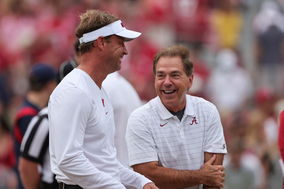 Oct 2, 2021; Tuscaloosa, Alabama, USA;  Mississippi Rebels head coach Lane Kiffin talks with Alabama Crimson Tide head coach Nick Saban before the start of an NCAA college football game at Bryant-Denny Stadium. Mandatory Credit: Butch Dill-USA TODAY Sports