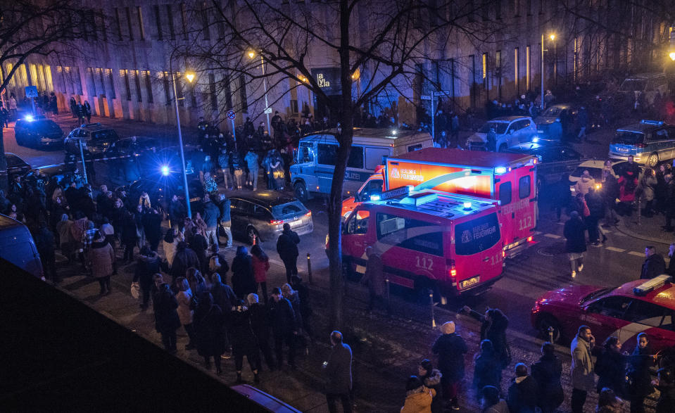 Police and emergency cars stand in a crowed near the Tempodrom venue after a shooting in Berlin, Germany, early Saturday, Feb. 15, 2020. According to police one person was killed. (Paul Zinken/dpa via AP)