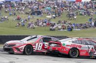 Kyle Busch (18) and Aric Almirola (10) spin out during a NASCAR Cup Series auto race Sunday, July 3, 2022, at Road America in Elkhart Lake, Wis. (AP Photo/Morry Gash)