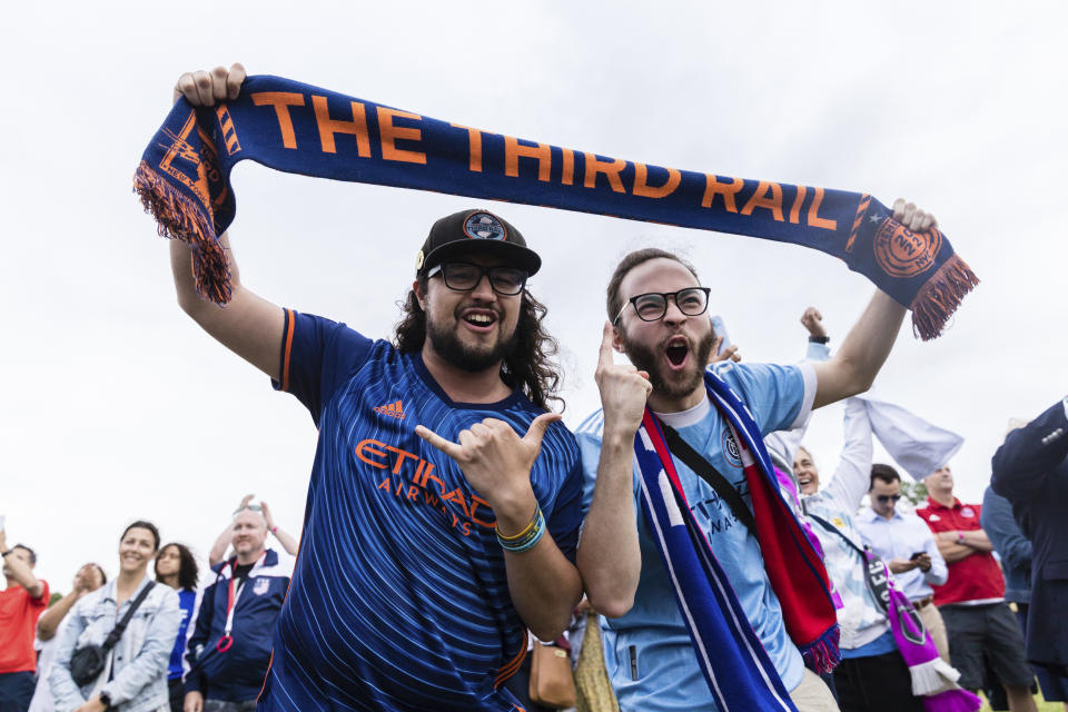 New York City FC fans react to the announcement that East Rutherford, New Jersey, will be a host city for the 2026 FIFA World Cup, during a selection watch part at Liberty State Park in Jersey City, N.J., Thursday, June 16, 2022. (AP Photo/Stefan Jeremiah)