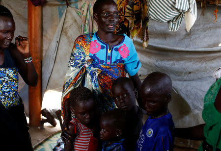 Nyagonga Machul, 38, embraces her children (L-R) Nyameer Mario, 6, Nyawan Mario, 4, Ruai Mario, 10, and Machiey Mario, 8, after being reunited with them at the United Nations Mission in South Sudan (UNMISS) Protection of Civilian site (CoP) in Juba, South Sudan, February 13, 2017. REUTERS/Siegfried Modola