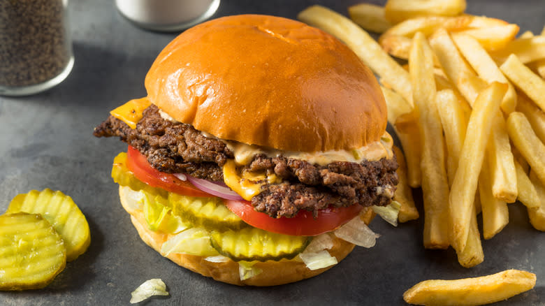 smash burger with fries and pickles