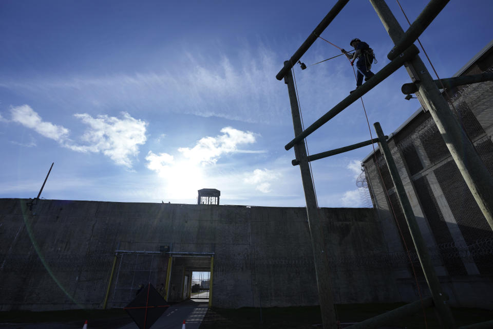 Prisoner Scott Steffes works on climbing at the Parnall Correctional Facility's Vocational Village in Jackson, Mich., Thursday, Dec. 1, 2022. Steffes, 37, whose release date is Jan. 17, 2023, is one of more than a dozen prisoners learning how to climb trees and trim branches around power lines as part of DTE Energy's plan to improve the utility's electric infrastructure. (AP Photo/Paul Sancya)