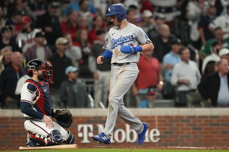 Los Angeles Dodgers' Trea Turner scores past Atlanta Braves catcher Travis d'Arnaud on an RBI single by Cody Bellinger during the fourth inning in Game 6 of baseball's National League Championship Series Saturday, Oct. 23, 2021, in Atlanta.(AP Photo/Ashley Landis)