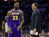 Los Angeles Lakers' head coach Luke Walton, right, talks things over with LeBron James, left, during the first half of an NBA basketball game against the Philadelphia 76ers, Sunday, Feb. 10, 2019, in Philadelphia. The 76ers won 143-120. (AP Photo/Chris Szagola)