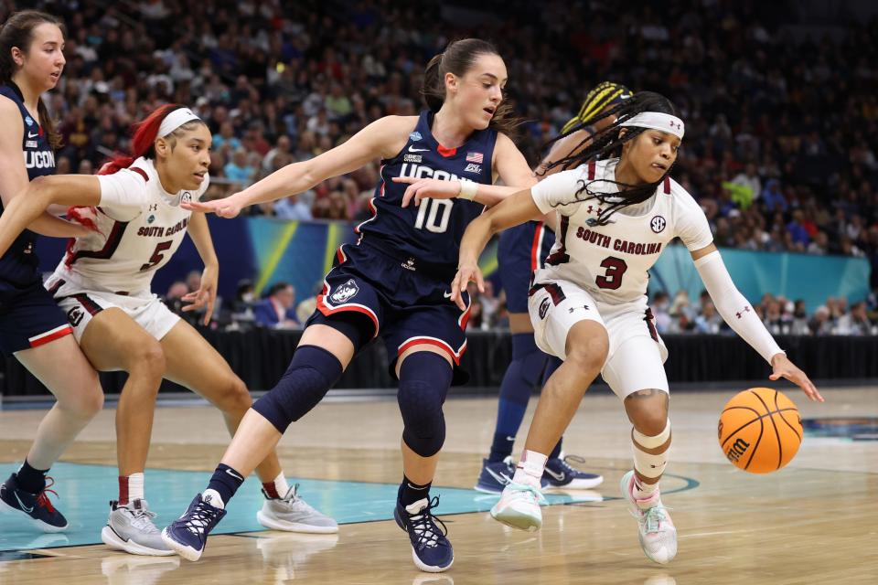 South Carolina guard Destanni Henderson (3) controls the ball as Connecticut guard Nika Muhl (10) defends during the championship game of the 2022 NCAA women's college basketball tournament at Target Center.