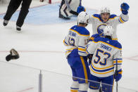 Buffalo Sabres left wing Jeff Skinner (53) celebrates his hat trick against the Seattle Kraken with teammates Peyton Krebs (19) and Jordan Greenway (12) during the third period of an NHL hockey game Monday, March 18, 2024, in Seattle. The Sabres won 6-2. (AP Photo/Lindsey Wasson)