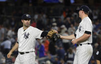 New York Yankees' Neil Walker, left, celebrates with relief pitcher Zach Britton after a baseball game against the Boston Red Sox pm Tuesday, Sept. 18, 2018, in New York. The Yankees won 3-2. (AP Photo/Frank Franklin II)