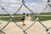 Visitors play on the field at the Field of Dreams movie site, Friday, June 5, 2020, in Dyersville, Iowa. Major League Baseball is building another field a few hundred yards down a corn-lined path from the famous movie site in eastern Iowa but unlike the original, it's unclear whether teams will show up for a game this time as the league and its players struggle to agree on plans for a coronavirus-shortened season. (AP Photo/Charlie Neibergall)