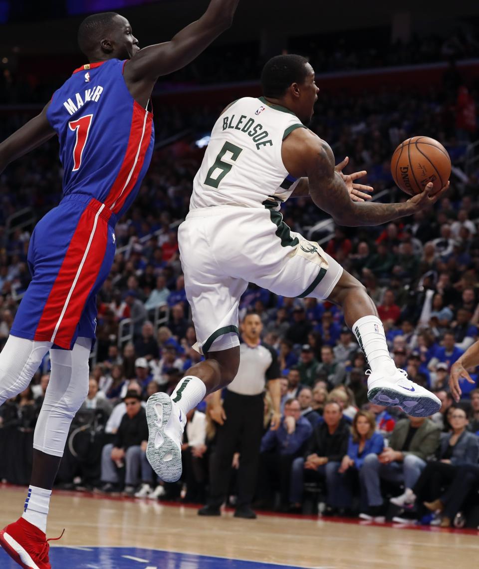 Milwaukee Bucks guard Eric Bledsoe (6) makes a layup as Detroit Pistons forward Thon Maker (7) defends during the first half of Game 3 of a first-round NBA basketball playoff series, Saturday, April 20, 2019, in Detroit. (AP Photo/Carlos Osorio)