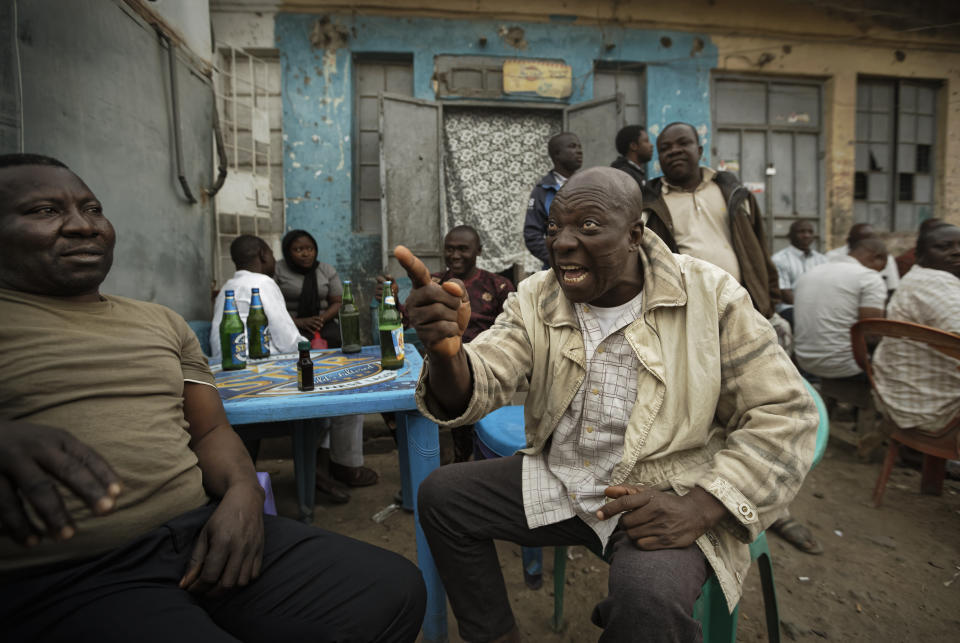 FILE - In this Feb. 16, 2019 fie photo, Nigerians engage in heated but friendly arguments about the postponement of the election, over beers at a street-side bar in the predominantly-Christian neighborhood of Sabon Gari in Kano, northern Nigeria. These African stories captured the world's attention in 2019 - and look to influence events on the continent in 2020. (AP Photo/Ben Curtis, File)