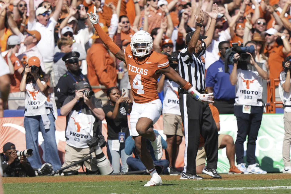 Texas defensive back Austin Jordan (4) celebrates scoring a touchdown after recovering a blocked punt in the endzone during the first half of an NCAA college football game against Oklahoma at the Cotton Bowl in Dallas, Saturday, Oct. 7, 2023. (AP Photo/LM Otero)