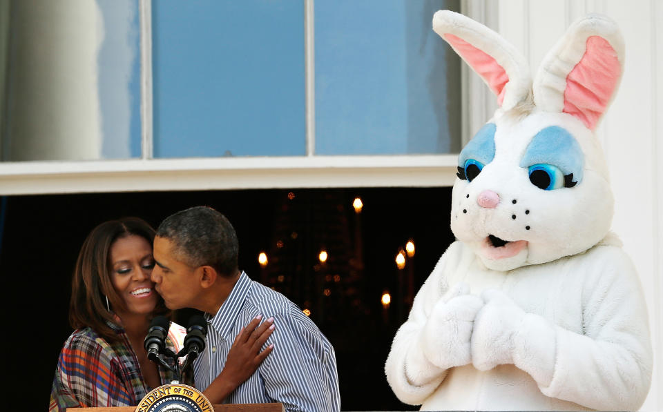 <p>The couple get in the Easter spirit by sharing a kiss by the Easter Bunny.<em> [Photo: Getty]</em> </p>