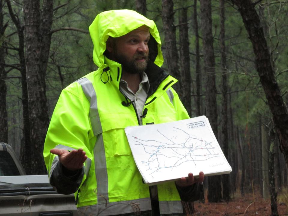 Jon Schleier, an archeologist with Fort Bragg's Cultural Resources Managment Program, shows a map of where Union and Confedrate soldiers traveled leading up to the March 10, 1865, Battle of Monroe's Crossroads during a March 10, 2023, guided tour to the battlefield site.