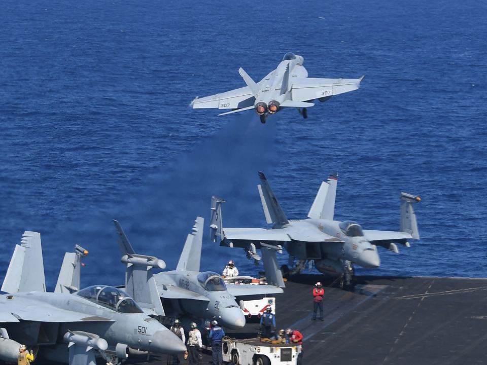 In the span of 20 minutes, 20 F-18 fighter jets took off and landed on the USS Theodore Roosevelt: TED ALJIBE/AFP/Getty Images