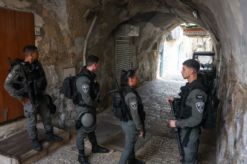 Israeli emergency responders work at the scene of a suspected stabbing attack, in Jerusalem