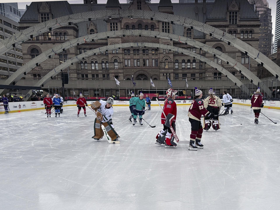 Professional Women’s Hockey League players skate outdoors at Nathan Phillips Square in Toronto, Thursday, Feb. 1, 2024, ahead of their 3-on-3 showcase at NHL All-Star Weekend. (AP Photo/Stephen Whyno)