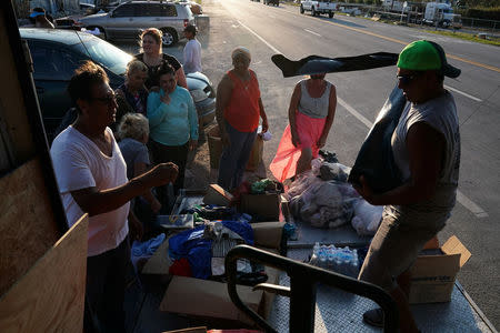 People receive goods donated for Hurricane Irma victims in Marathon, Florida, U.S., September 18, 2017. REUTERS/Carlo Allegri