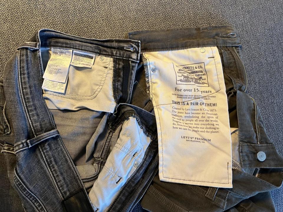 Close-up of a pair of jeans with the inside pocket visible, displaying care instructions and Levi's branding