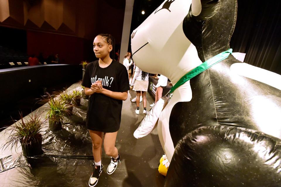 Taliah Scott walks past the inflatable cow that was on stage during the ceremony naming her Miss Basketball. St. Johns Country Day Girls Basketball senior guard Taliah Scott added another award to her growing list by being awarded the Florida Dairy Farmers Miss Basketball award at her school Wednesday, April 12, 2023. Bob Self/Florida Times-Union-USA TODAY NETWORK