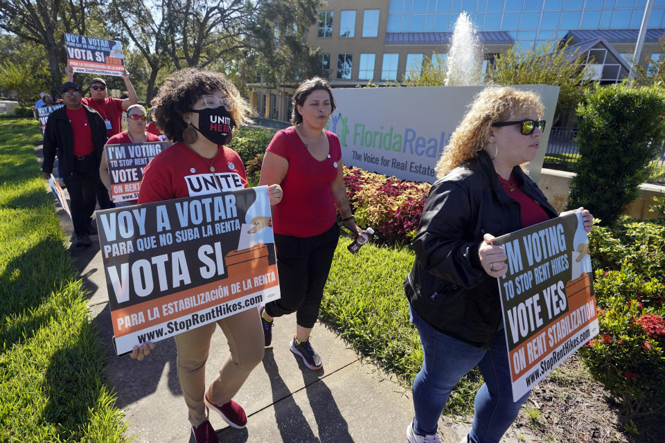 FILE - Rent control advocates for Orange County demonstrate in front of the Florida Realtors office building on Oct. 22, 2022, in Orlando, Fla. Ballot measures to build more affordable housing and protect tenants from soaring rent increases were plentiful and fared well in last week's midterm elections. The activity reflected growing angst over record high rents exacerbated by inflation and a dearth of homes. (AP Photo/John Raoux, File)