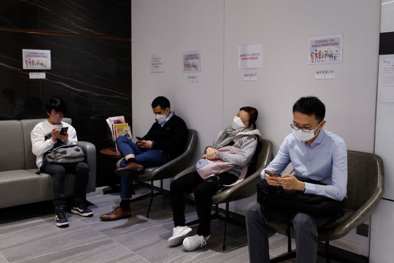 People wait to receive a dose of the coronavirus disease (COVID-19) vaccine at a private clinic in Hong Kong