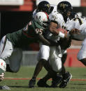 FILE- In this Nov. 20, 2004, file photo, Miami's Bryan Pata sacks Wake Forest quarterback Cory Randolph in the first half of an college football game in Miami. Rashaun Jones, 35, of Lake City, a former University of Miami football player was arrested Thursday, Aug. 19, 2021, in connection with the 2006 fatal shooting of his teammate Bryan Pata. Pata, a 22-year-old, 6-foot-4, 280-pound defensive lineman, was shot several times outside of his Kendall, Fla., apartment the night of Nov. 7, 2006. (Al Diaz/Miami Herald via AP, File)