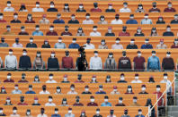 A TV cameraman walks through the spectators' seats which are covered with pictures of fans, before the start of a regular season baseball game between Hanwha Eagles and SK Wyverns in Incheon, South Korea, Tuesday, May 5, 2020. South Korea's professional baseball league start its new season on May 5, initially without fans, following a postponement over the coronavirus. (AP Photo/Lee Jin-man)