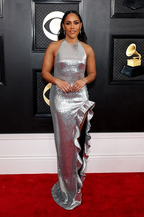 Alex Scott posing on the Grammys red carpet in her gorgeous silver dress