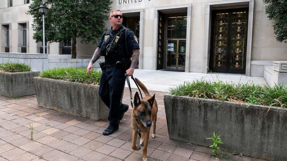PHOTO: A Homeland Security canine unit sweeps one of the entrances to the E. Barrett Prettyman U.S. Courthouse in Washington, D.C., Aug. 3, 2023. (Roberto Schmidt/Getty Images)