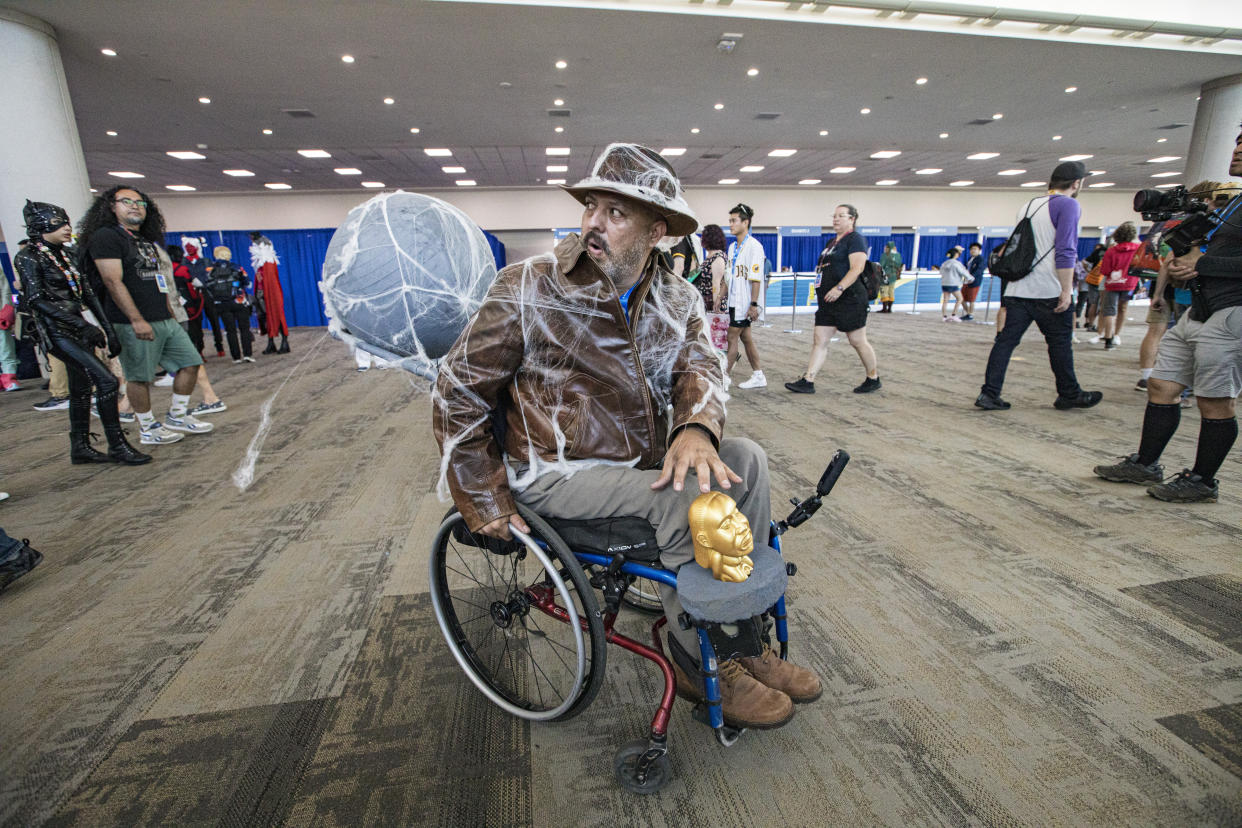 Indiana Jones cosplayer Angel Frost, complete with a boulder in pursuit.