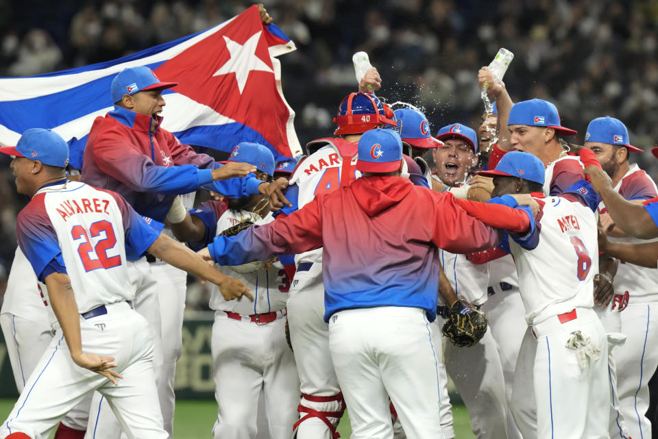 Cuban players celebrate after defeating Australia in their World Baseball Classic quarterfinal game at the Tokyo Dome Tokyo, Wednesday, March 15, 2023. (AP Photo/Eugene Hoshiko)