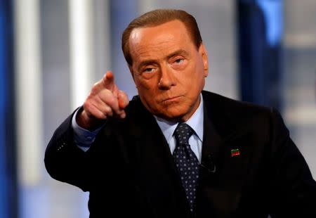 FILE PHOTO: Italy's former Prime Minister Silvio Berlusconi gestures as he attends television talk show "Porta a Porta" (Door to Door) in Rome, Italy, November 30, 2016. REUTERS/Remo Casilli/File Photo
