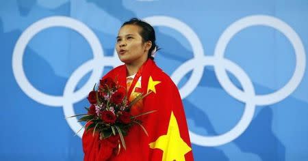 Chen Xiexia of China sings the national anthem after receiving her gold medal for the women's 48kg Group A weightlifting competition at the Beijing 2008 Olympic Games August 9, 2008. REUTERS/Oleg Popov (CHINA)