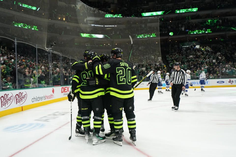 Dallas Stars center Tyler Seguin (91) celebrates his first period goal with defenseman Ryan Suter (20) and teammates during an NHL hockey game against the Tampa Bay Lightning, Saturday, Dec. 2, 2023, in Dallas. The Stars won 8-1. (AP Photo/Julio Cortez)
