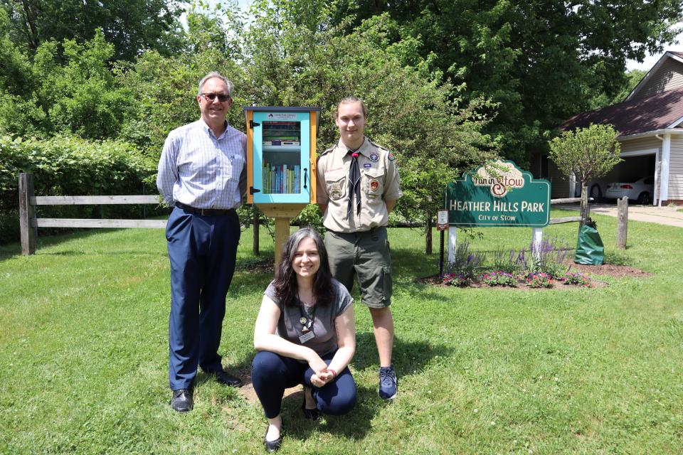 Pictured with the Heather Hills Little Free Library are Stow Mayor John Pribonic, Boy Scout Ben Ehrhardt and  Amanda Rome, outreach librarian for the Stow-Munroe Falls Public Library.