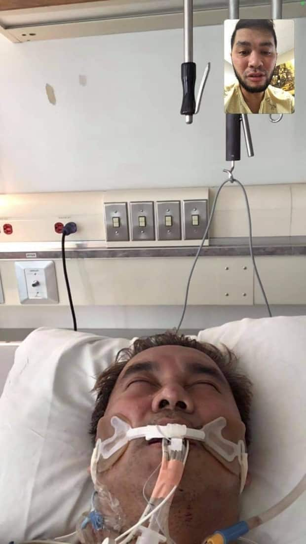 In a screenshot from a video call, Rey Capariño's husband speaks to him while Capariño was intubated in the Regina ICU. 