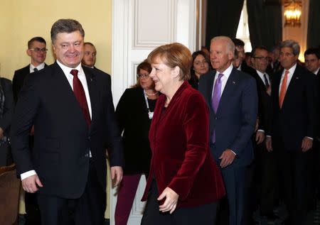 Ukraine's President Petro Poroshenko, German Chancellor Angela Merkel and U.S. Vice President Joe Biden arrive for a meeting as U.S. Secretary of State John Kerry (L-R) looks on during the 51st Munich Security Conference at the 'Bayerischer Hof' hotel in Munich February 7, 2015. REUTERS/Michaela Rehle