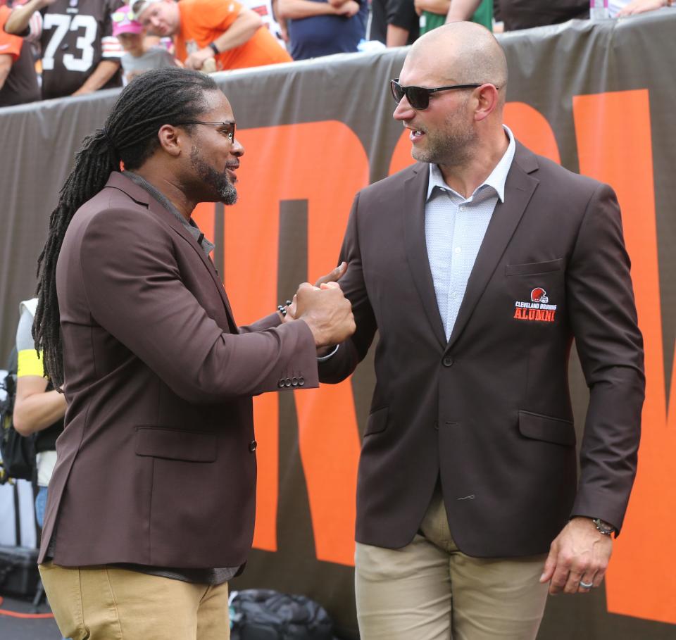 Former Browns offensive tackle Joe Thomas (right) is congratulated by Josh Cribbs after being inducted into the Browns Ring of Honor during a game against the New York Jets on Sunday, Sept. 18, 2022 in Cleveland.