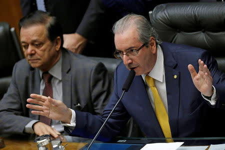 President of the Chamber of Deputies Eduardo Cunha (R) reacts next to congressman Jovair Arantes during a session to review the request for Brazilian President Dilma Rousseff's impeachment at the Chamber of Deputies in Brasilia, Brazil April 15, 2016. REUTERS/Ueslei Marcelino