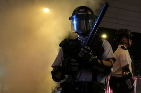 Riot police react as they disperse crowds of anti-government protesters during a rally outside Mong Kok police station, in Hong Kong