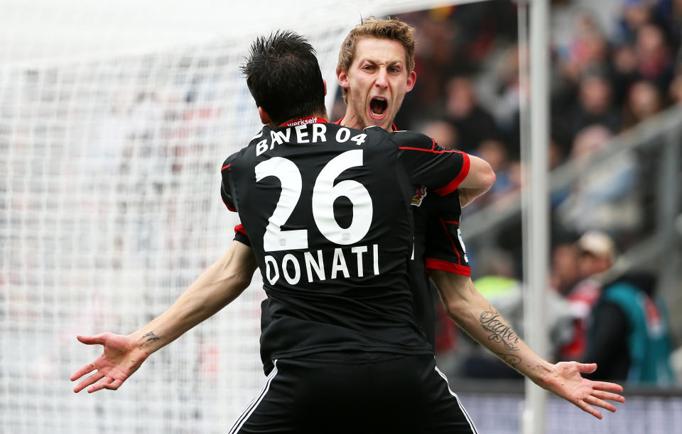 Leverkusen's Stefan Kiessling, right, celebrates with Giulio Donati after scoring during the German first division Bundesliga soccer match between Bayer Leverkusen and Hertha BSC Berlin in Leverkusen, Germany, Sunday April 13,2014. (AP Photo/Rolf Vennenbernd/dpa)