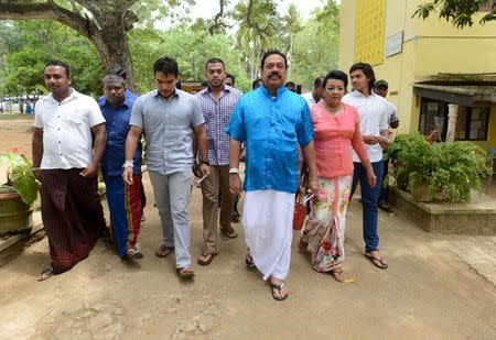 Sri Lanka's former President Mahinda Rajapaksa (3rd R) arrives at a polling station during the general election in Medamulana August 17, 2015. REUTERS/Stringer
